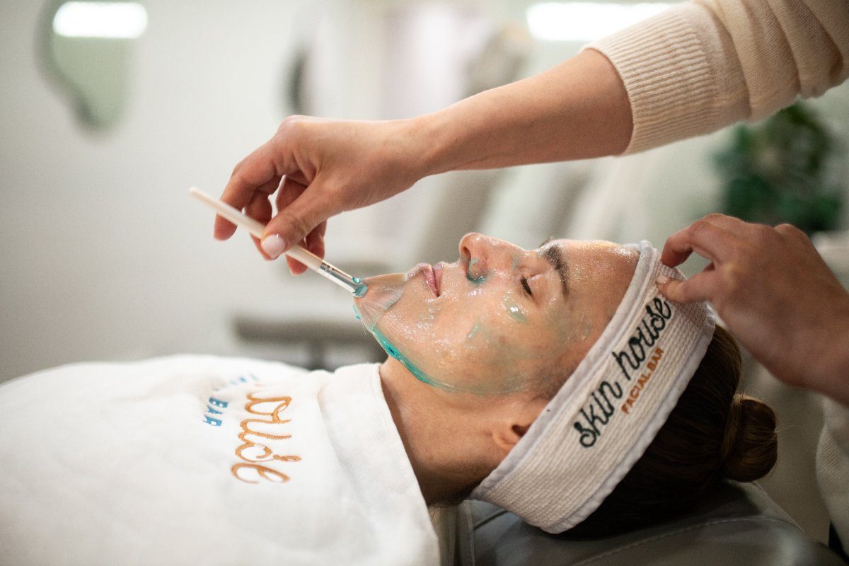 Treatment being brushed on during a Reset Facial